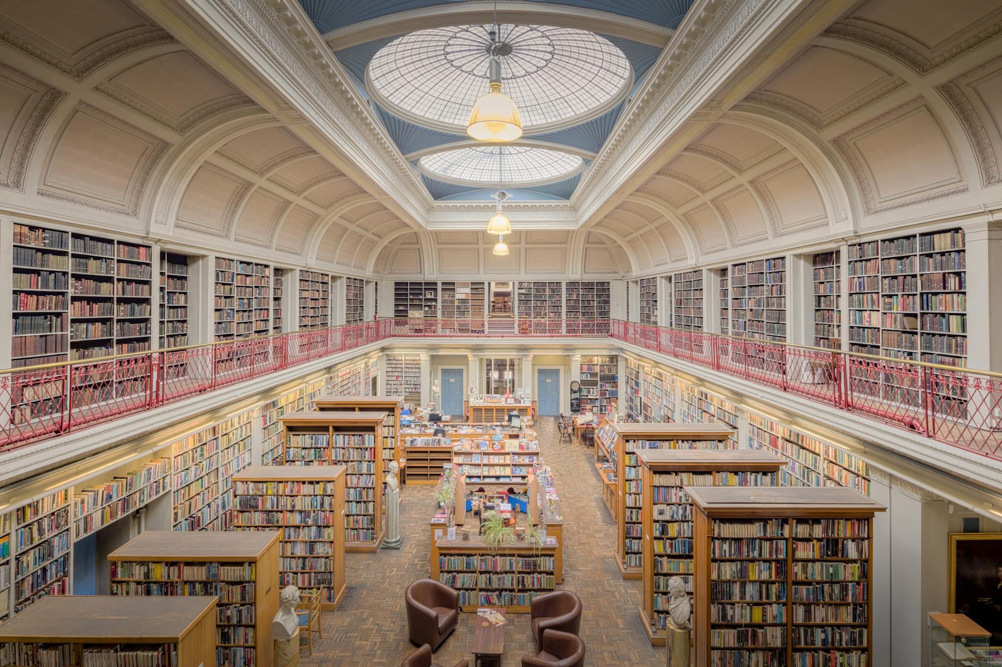 Beautiful interior of a historic library in England with bookshelves and dome ceiling.